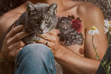 Man with cat tattoo and his pet cat