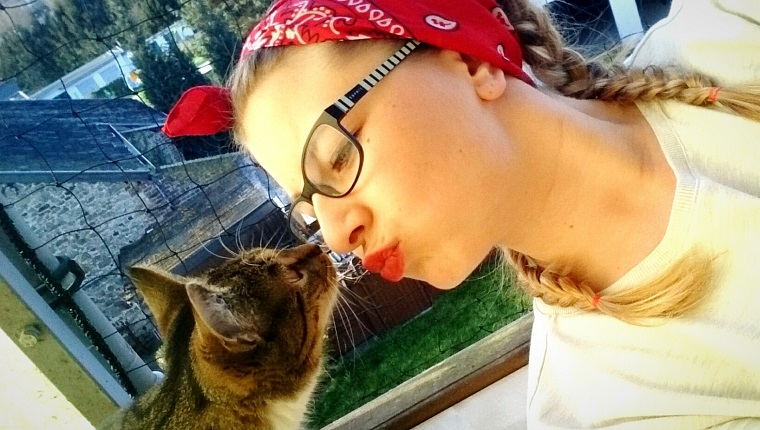 Tilt Shot Of Woman Puckering In Front Of Cat