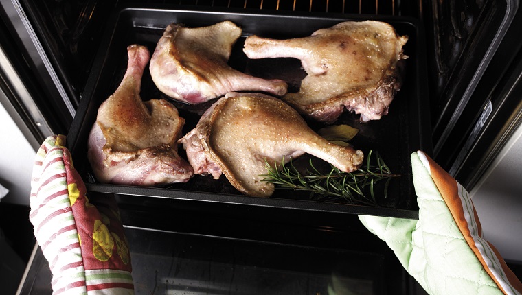 Raw goose meat on baking tray, elevated view