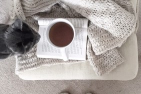 Low Section Of Woman With Coffee Cup On Table