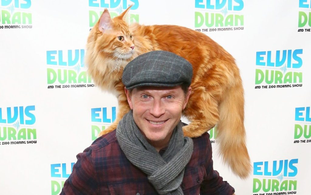 Bobby Flay carries his Maine Coon cat Nacho on his shoulders